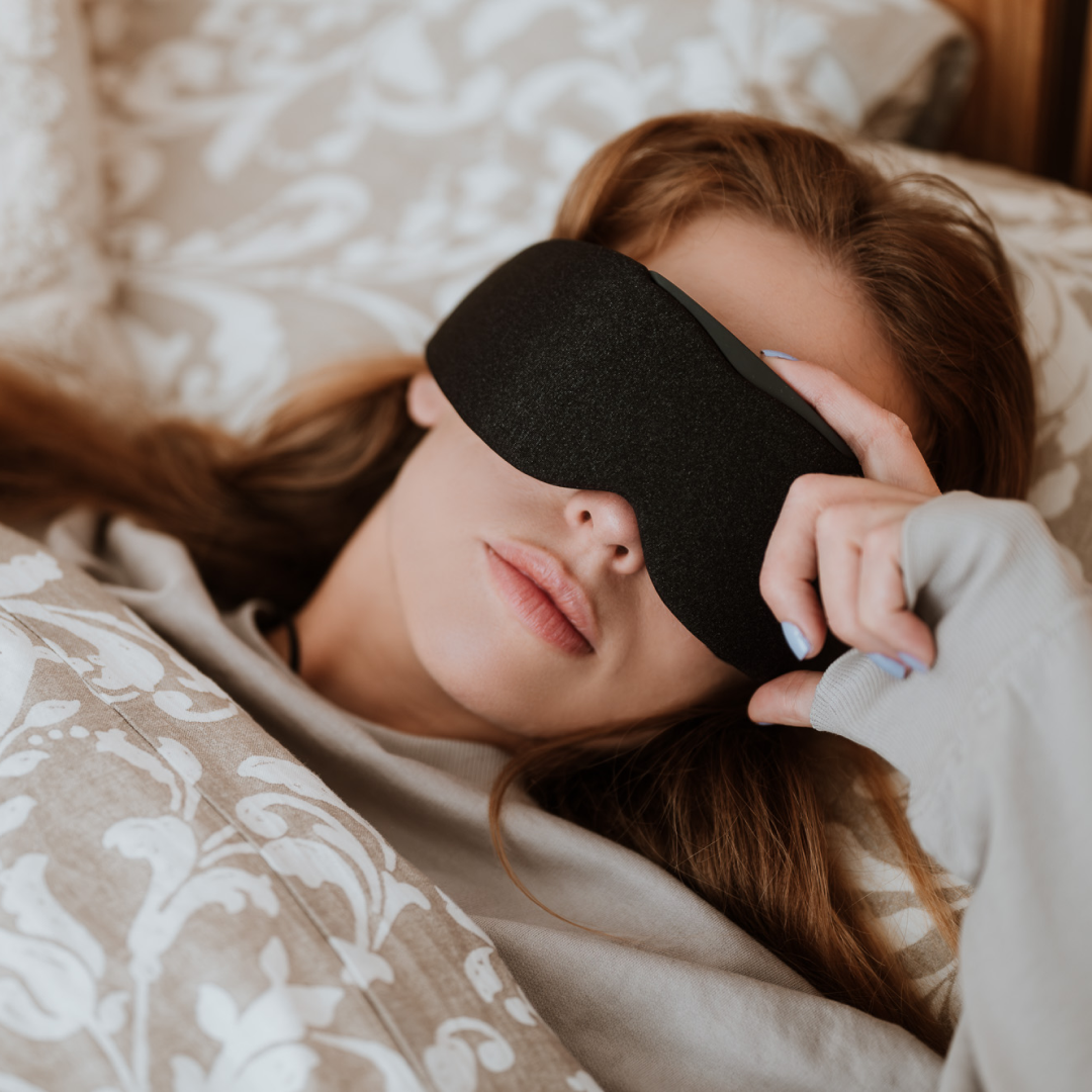 Woman side-sleeping comfortably on the bed with Midnight Black Aura Smart Sleep Mask